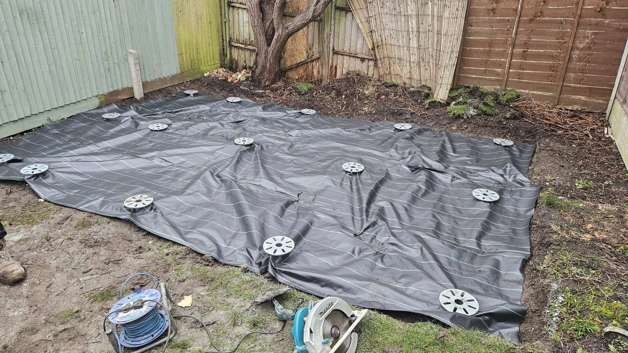 Completed foundation in a fenced residential garden
