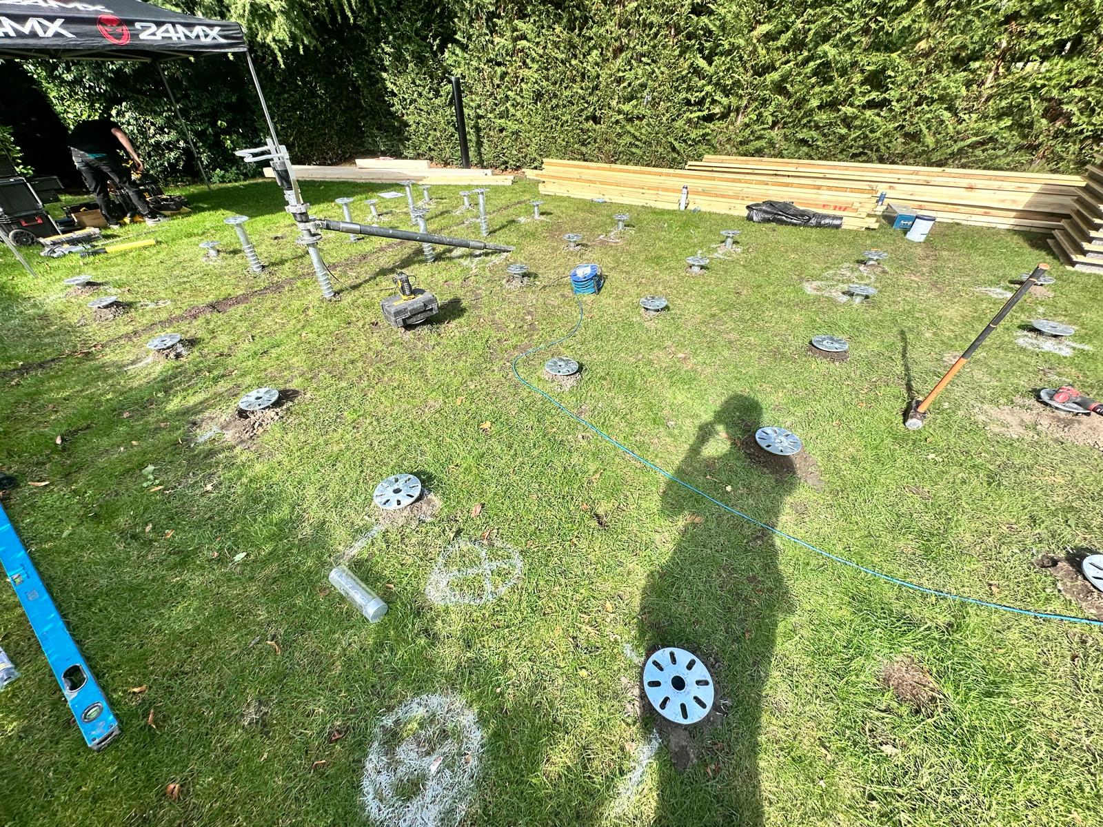 Installed screws casting long shadows across a lawn